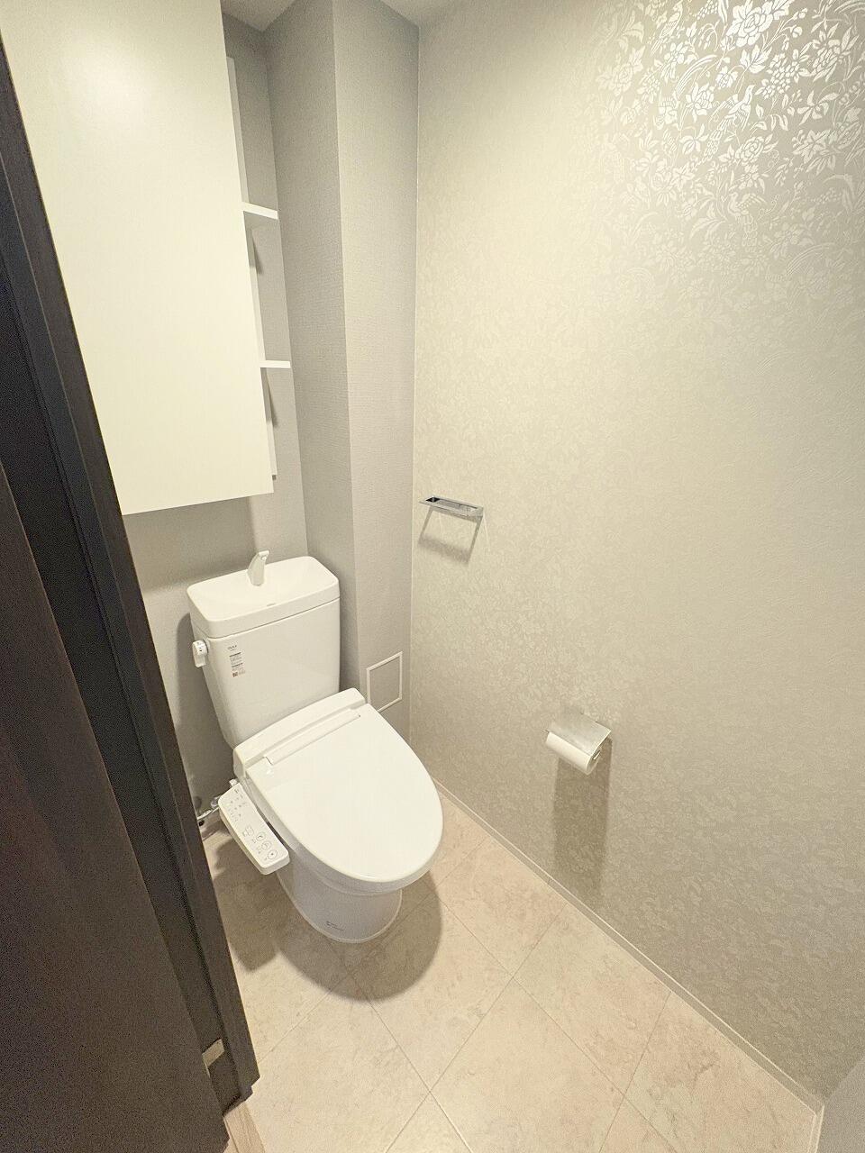 <p>2025年10月撮影/トイレ<br />
背面の吊戸棚にトイレットペーパーや掃除用具がすっきり収納できます。</p>